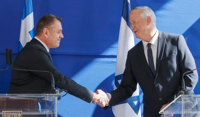 Israeli Defence Minister Benny Gantz (R) and Greek counterpart Nikos Panagiotopoulos shake hands as they arrive to hold joint statements at the Israeli Defence Minister in the coastal city of Tel Aviv, on January 20, 2022. (AFP)