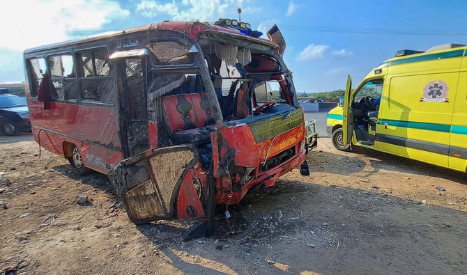 Egyptian emergency services gather near a damaged minibus which that was pulled out of a water canal following a crash near the Nile Delta city of Mansoura, some 120Km north of the capital, on November 12, 2022. (AFP/File)