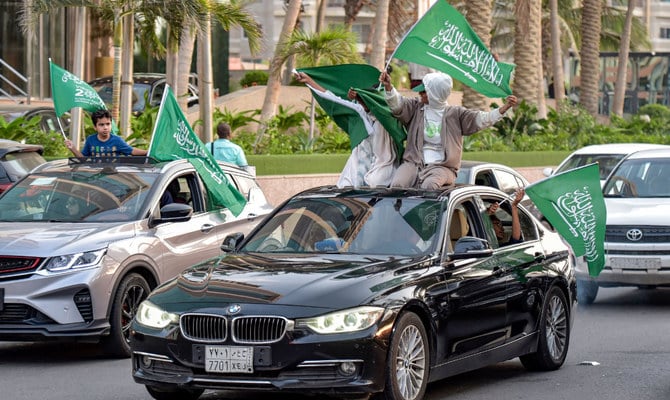 Saudi football fans wave their country's flags from vehicles as they celebrate their win over Argentina in the Qatar 2022 World Cup on Tuesday. (AFP)