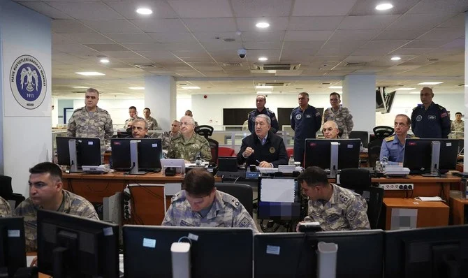 Turkey's Defense Minister Hulusi Akar (C) chairs a new air operation in northern regions of Iraq and Syria with members of the Turkish Armed Forces (TSK) command level at the Turkish Air Force Operations Centre in Ankara. (AFP)