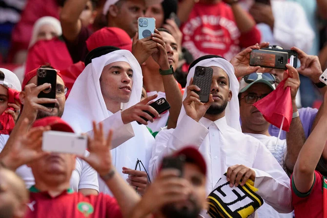 Spectators hold cell phones as they wait in the stands for the World Cup group F soccer match between Morocco and Croatia, at the Al Bayt Stadium in Al Khor on Wednesday. (AP)