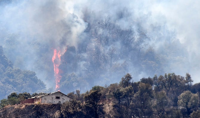 Heavy smoke rises during a wildfire in the forested hills of the Kabylie region, east of the Algerian capital Algiers, on August 11, 2021. (AFP/File)