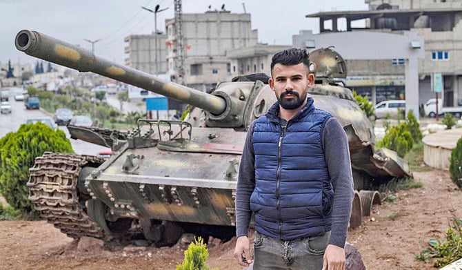 A man stands at the ‘Free Woman’ square in the northern Syrian city of Kobane, a Kurdish-majority area near the Turkish border. (AFP)