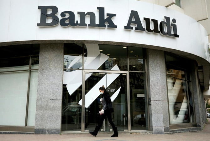 A disabled woman was carried by her son to the Bank Audi branch in the Salim Salam neighborhood in Beirut. She staged a sit-in after the bank’s management refused to release her $20,000 deposit. (Reuters/File)