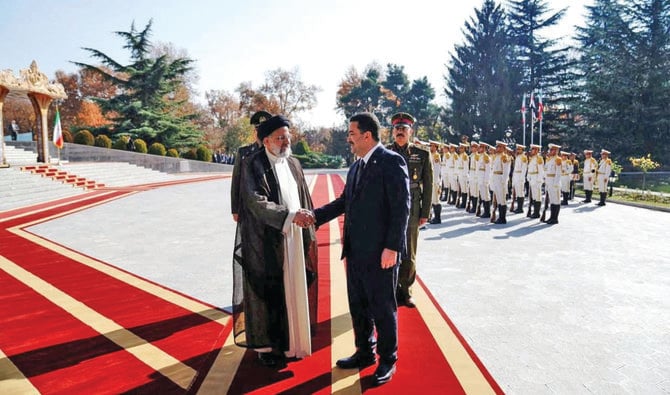 Iran’s President Ebrahim Raisi welcomes Iraq’s Prime Minister Mohammed Shia Al-Sudani. (AP)