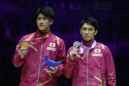 Japan's Gold medalist Daiki Hashimoto (left) and Bronze medalist Wataru Tanigawa celebrate during a medal ceremony. (AP)