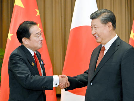 Japanese Prime Minister Fumio Kishida and Chinese President Xi Jinping shake hands at the start of their meeting, on the sidelines for the Asia-Pacific Economic Cooperation, APEC, forum, Thursday, Nov. 17, 2022, in Bangkok, Thailand. (Kyodo News via AP)