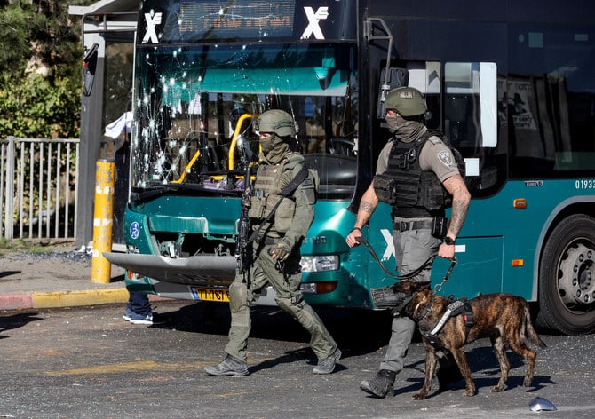 Israeli border police walk past a damaged bus following explosions in Jerusalem November 23, 2022. (Reuters)
