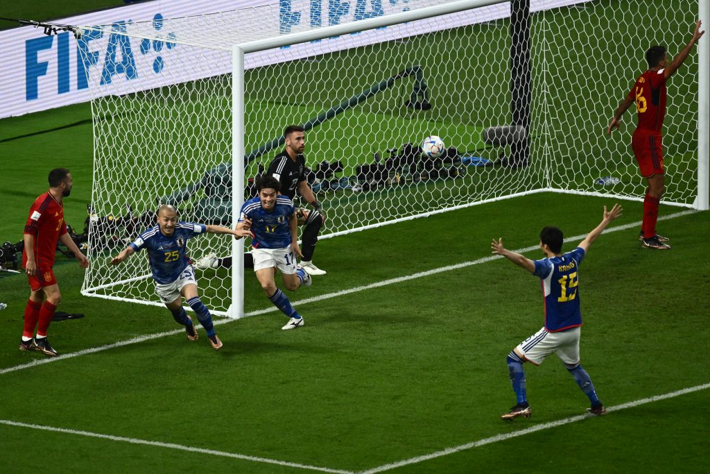 Japan's midfielder #17 Ao Tanaka celebrates scoring his team's second goal with his teammates during the Qatar 2022 World Cup Group E football match between Japan and Spain at the Khalifa International Stadium in Doha on December 1, 2022. (AFP)