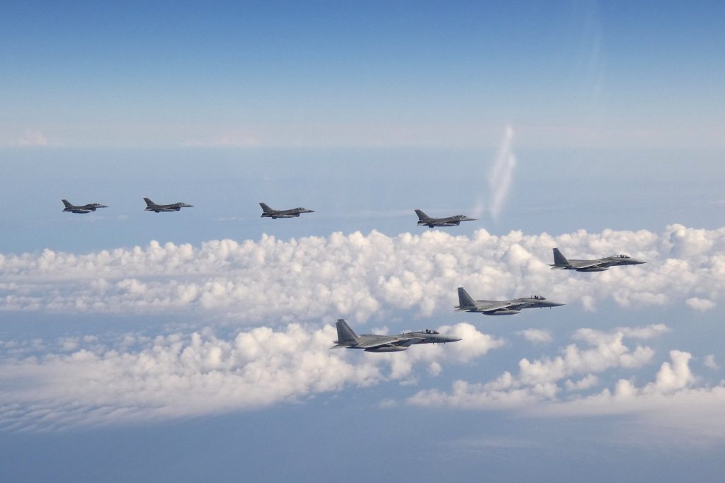 Photo provided by the Joint Staff of the Japanese Self-Defense Force, three F-15 warplanes of the Japanese Self-Defense Force, front, and four F-16 fighters of the U.S. Armed Forces fly over the Sea of Japan, May. 25, 2022. (File/AP)