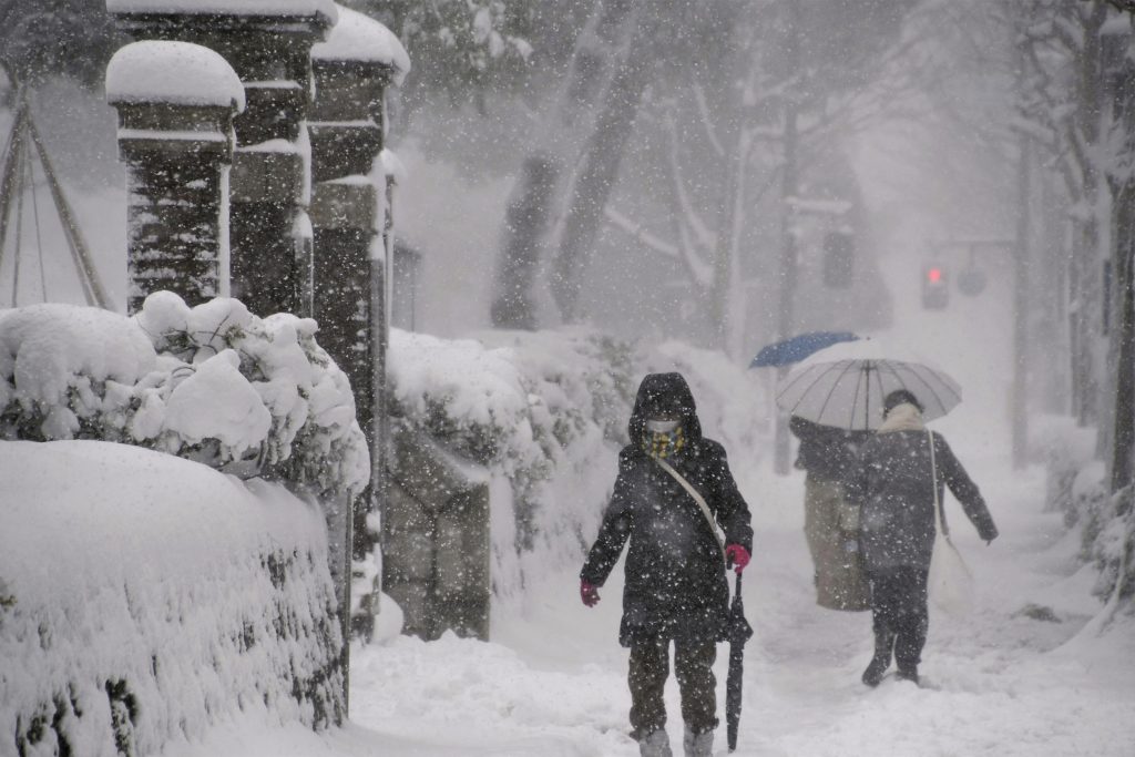 People make their way in the heavy snow in Kanazawa, Ishikawa Prefecture, central Japan, Dec. 23, 2022. (Reuters)
