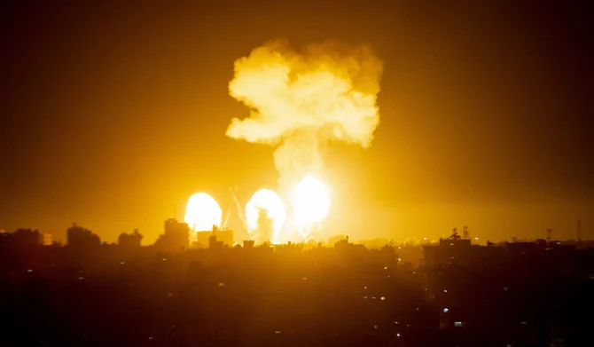 A ball of fire and a plume of smoke rise above buildings in south of City Strip as Israeli warplanes target the Palestinian enclave, early on, on December 4, 2022. (AFP)