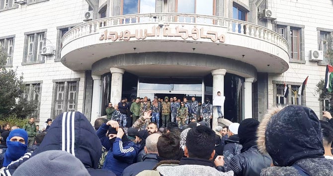 People gather as they take part in a protest in Sweida, Syria. ( Suwayda 24 via Reuters)