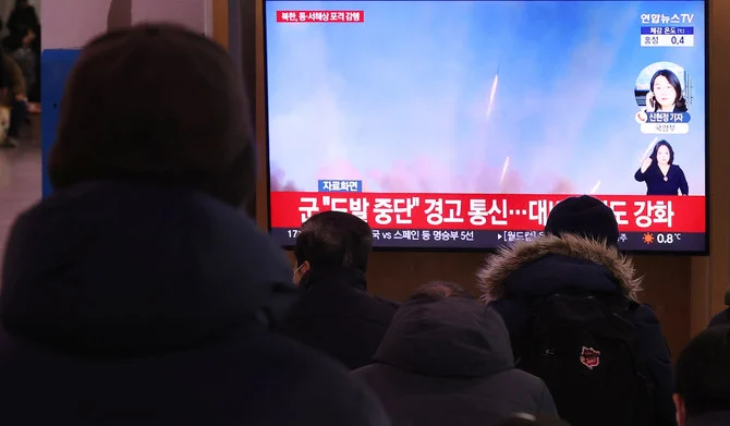 People watch a report on North Korea's artillery firings, at Seoul Station in Seoul, South Korea 05 December 2022. (EPA)