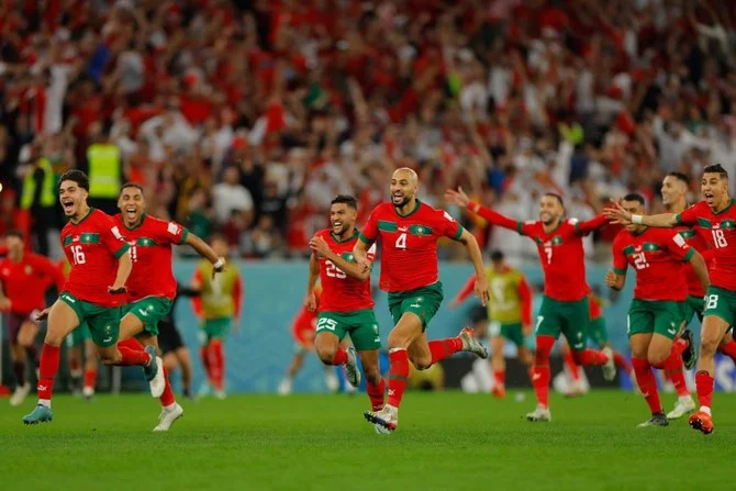 Morocco players celebrate after winning the penalty shoot-out against Spain at Education City Stadium in Al-Rayyan, west of Doha, Dec. 6, 2022. (AFP)