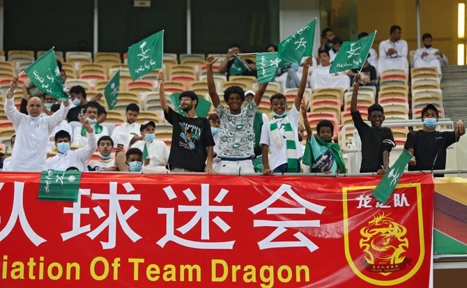 Saudi supporters cheer during Asian Qualifiers for the World Cup match between Saudi Arabia and China, at the King Abdullah Sport City Stadium in Jeddah, Saudi Arabia. (AFP)