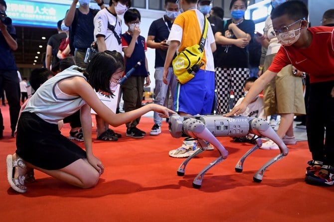 Children play with a quadruped robot at the 2022 World Robot Conference in Beijing. (All photos: AFP)