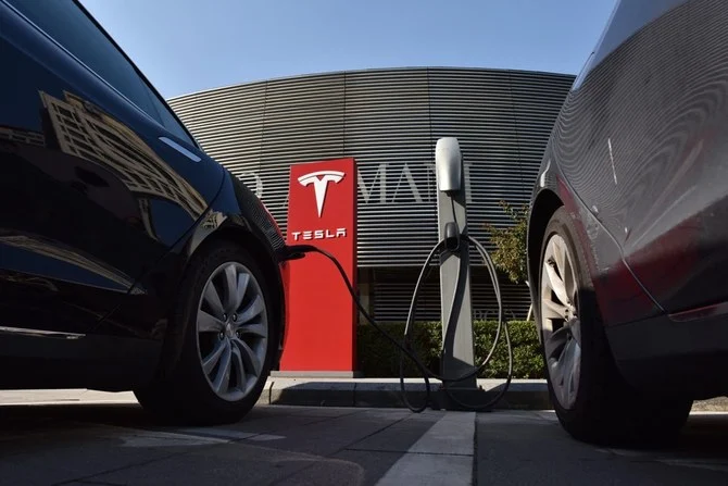 Tesla cars charge at a charging station outside a shopping mall in Beijing. (AFP)