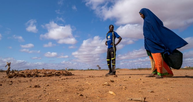 Fartum Issack, right, and her husband, Adan, stand by the grave of their 1-year-old daughter at a displacement camp on the outskirts of Dollow, Somalia. (AP)