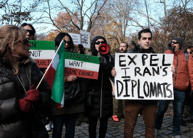 People gather outside of an Iranian diplomat's residence to denounce the Iranian government and the recent execution of protesters. (FILE/AFP)