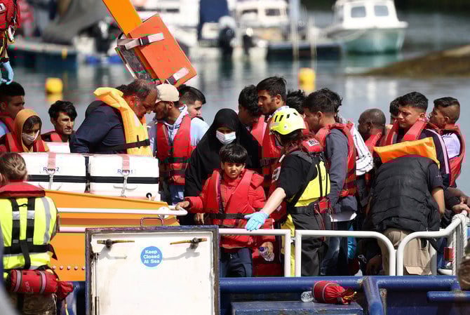Migrants arrive at Dover harbour on board a Border Force vessel, after being rescued while attempting to cross the English Channel, in Dover, Britain, August 24, 2022. (Reuters)