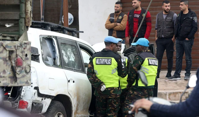 Members of the UN peacekeepers forces gather near a bullet-riddled car at the site where a UN peacekeeping force UNIFIL convoy came under small arms fire on December 15, 2022. (AFP)
