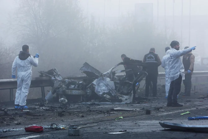 Police forensic experts examine the car bomb which targeted an armored police van carrying officers in Diyarbakir in southeast Turkiye. (Reuters)