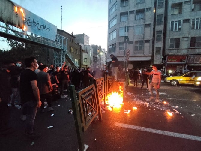 People light a fire during a protest over the death of Mahsa Amini, in Tehran. (File/Reuters)