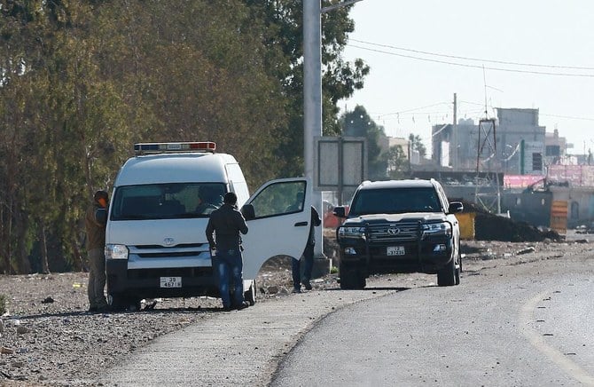 A forensic and laboratories department team collects evidence on December 16, 2022 from the scene of riots, hours after a senior police officer was shot dead in the southern Jordanian city of Maan. (AFP)