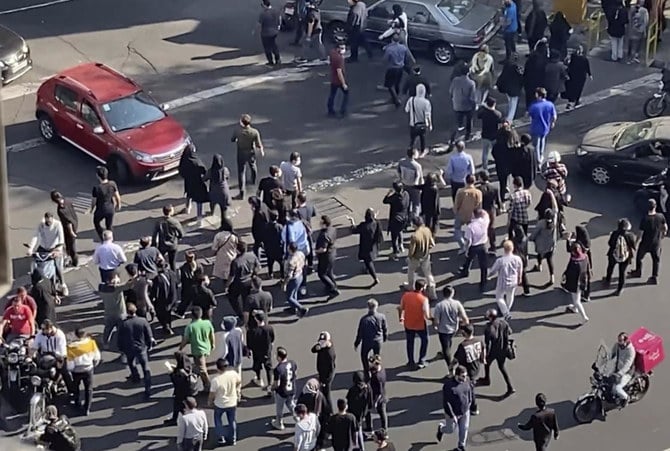 In this frame grab from video taken by an individual not employed by AP and obtained by AP outside Iran shows people blocking an intersection during a protest to mark 40 days since the death of Mahsa Amini, in Tehran on Oct. 26, 2022. (AP/File)