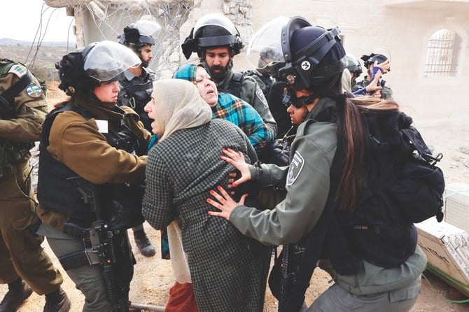 Israeli security forces block Palestinians trying to stop demolition of their homes on the West Bank. (AP)