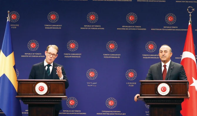 Turkiye’s Foreign Minister Mevlut Cavusoglu, right, with Sweden’s Foreign Minister Tobias Billstrom in Ankara on Thursday. (AP)