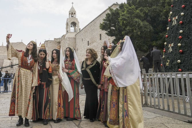 Women pose for a photo as they visit the Church of the Nativity(AP)