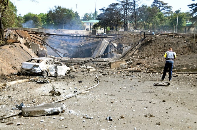 A burned out vehicle marks the spot where a gas tanker exploded under a bridge in Boksburg, east of Johannesburg, on Dec. 24, 2022. (AP)