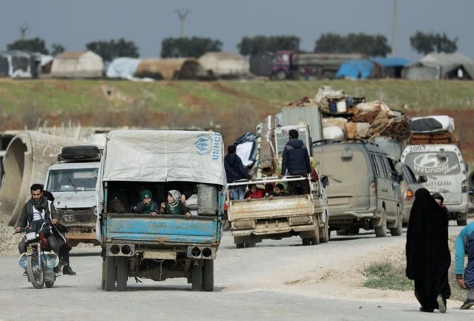 Internally displaced people ride on trucks with their belongings in Afrin, Syria Feb. 18, 2020. (Reuters)