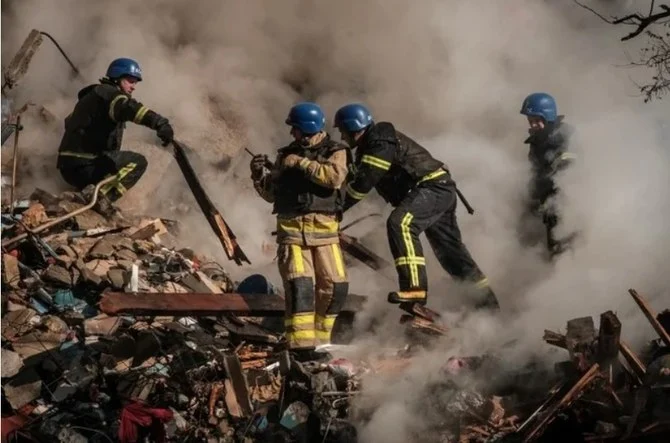 Ukrainian firefighters work on a destroyed building after a drone attack by Russia on Kyiv on Oct. 17, 2022. (File/AFP)