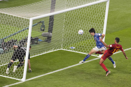 Japan's Ao Tanaka (second right) heads the ball to score his side's second goal during the World Cup group E soccer match against Spain, at the Khalifa International Stadium in Doha, Qatar, Thursday, Dec. 1, 2022. (AP)