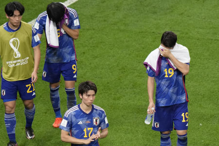 Japan players are dejected after losing to Croatia in the World Cup round of 16 soccer match. (AP)