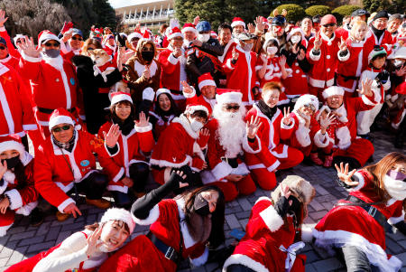 People dressed in Santa Claus costumes gather before their Xmas Toy Run parade to rev up the holiday spirit. (Reuters)