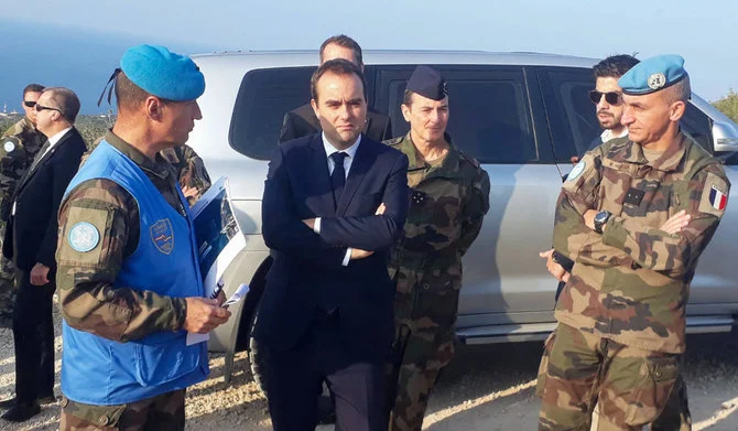 A member of the UN Interim Force in Lebanon speaks with French Armies Minister Sebastien Lecornu on Saturday during a tour of the ‘blue line’ area, a demarcation line drawn by the UN to mark Israel’s withdrawal from southern Lebanon in 2000, near the southern town of Naqoura. (AFP)