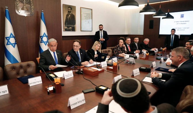Israeli Prime Minister Benjamin Netanyahu (L) chairs the weekly cabinet meeting in Jerusalem on January 3, 2023. (AFP)