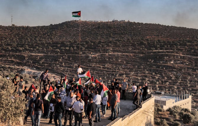 Palestinian protesters gather during a demonstration against the Israeli settlers' wildcat outpost of Eviatar, in the town of Beita, near the occupied West Bank city of Nablus. (AFP file photo)