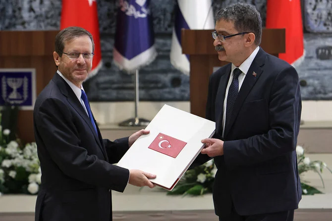 Turkiye's ambassador to Israel Sakir Ozkan Torunlar presents his credentials to Israeli President Isaac Herzog, in Jerusalem after Turkiye and Israel announced full restoration of relations. (AFP)