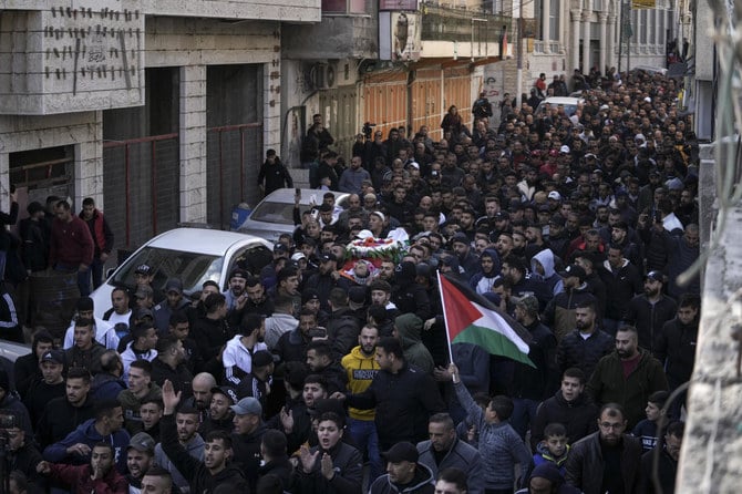 Mourners carry the body of Palestinian Samir Aslan, 41, during his funeral in the West Bank refugee camp of Qalandia, north of Ramallah, Thursday, Jan. 12, 2023. (AP Photo)