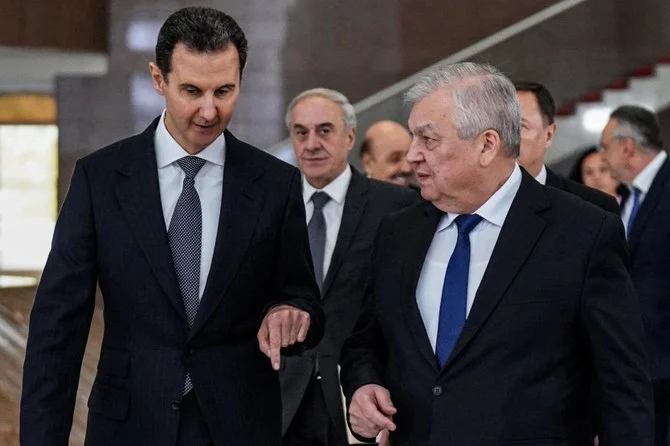 Syria's President Bashar Al-Assad (L) receiving Russia's Special Envoy for Syria Alexander Lavrentiev (R) and his accompanying delegation in the capital Damascus (AFP)
