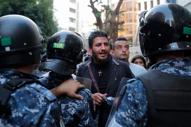 This file photo take on July 13, 2021 shows Lebanese activist William Noun (C), whose brother was killed in the massive port explosion in Beirut in August 2020, during a demonstration outside the residence of the minister of interior in the Lebanese capital against the authorities' lack of action to achieve justice for the victims of the bombing. (AFP)