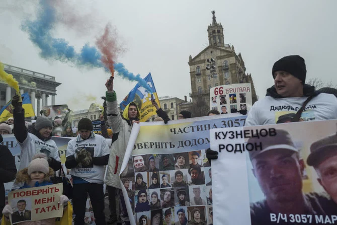 Ukrainians holding pictures of missing soldiers during a demonstration in downtown Kyiv, on Jan. 14, 2023. (AP)
