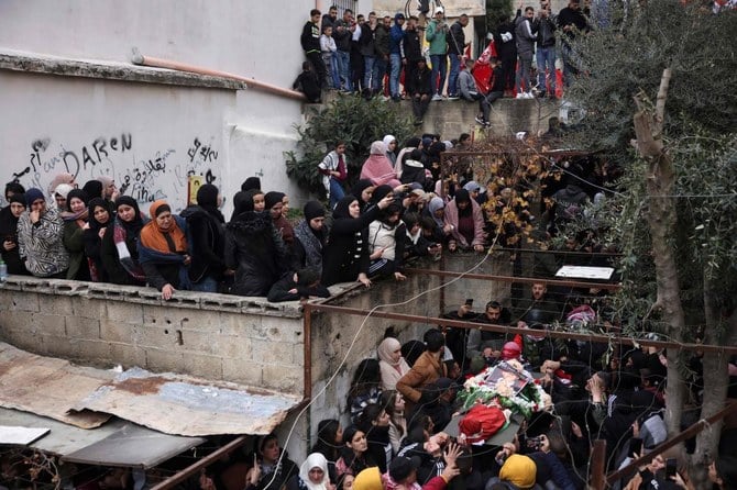 Mourners attend the funeral of Omar Khumour, 14, in Bethlehem’s Dheisheh refugee camp, in the occupied West Bank, on January 16, 2023. (AFP)