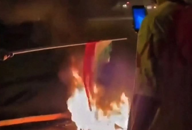 Protesters in the Iranian Kurdish city of Bukan burn a national flag and chant “death to Khamenei.” (Screen grab from UGA video)