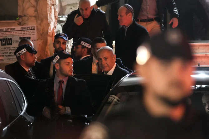 Israeli Prime Minister Benjamin Netanyahu enters his car after visiting his ally Aryeh Deri, a Cabinet minister and the head of the ultra-Orthodox Shas party, In Jerusalem, Wednesday, Jan. 18, 2023. (AP Photo/Mahmoud Illean)